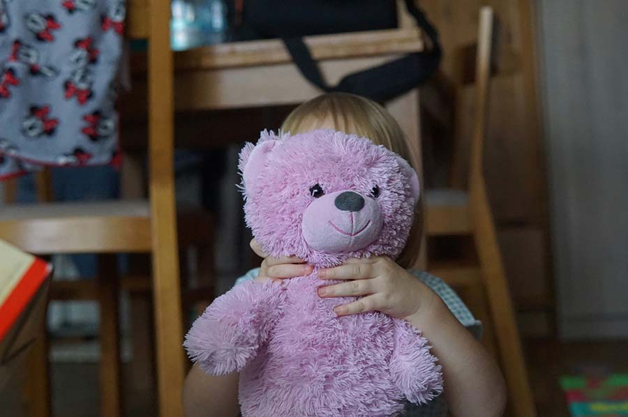 child holding a teddy bear