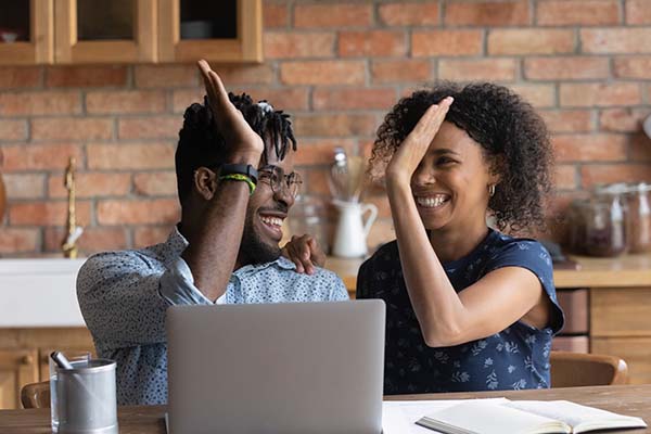 business partners high five each other in their office