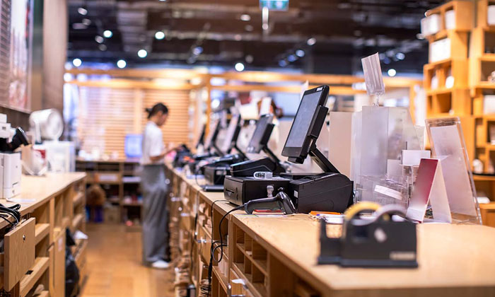 person standing at a cash register in a store