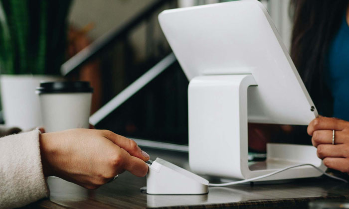 customer checking out using tap to pay terminal
