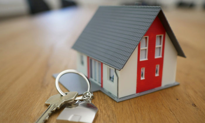 house keys on a counter next to a toy house