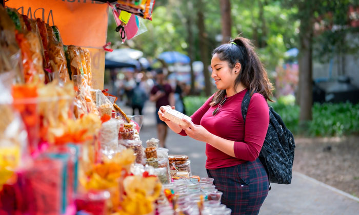 young woman shopping while traveling in a new country