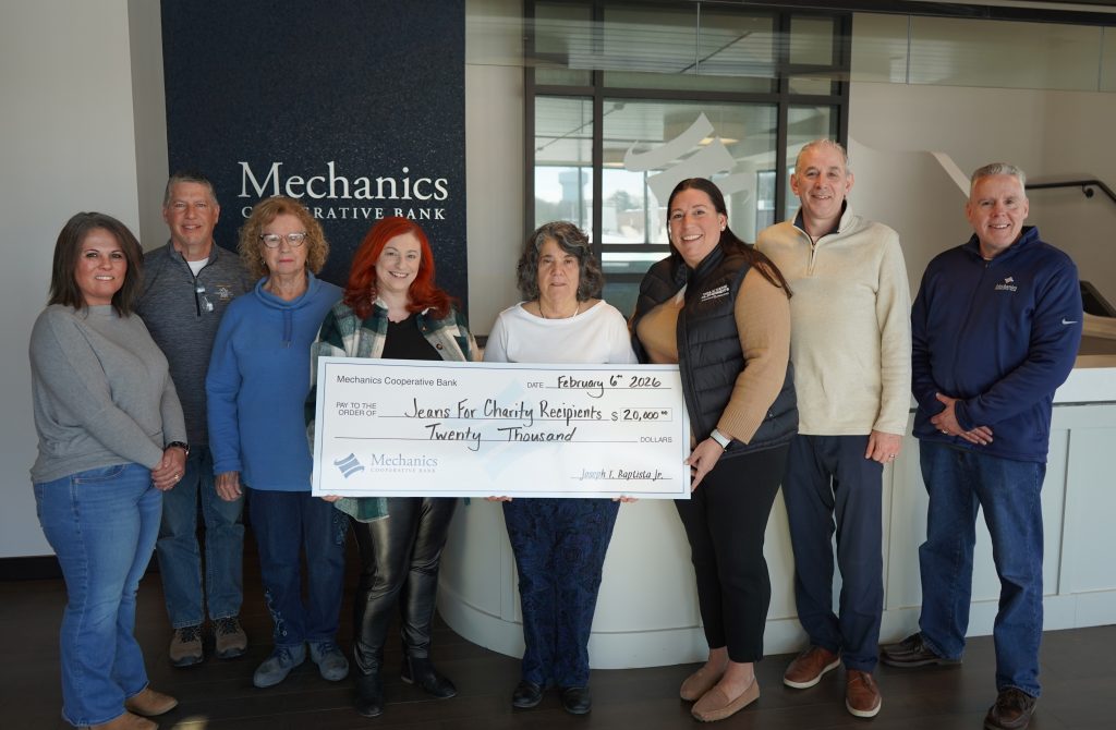 Mechanics Cooperative Bank employees present a $20,000 donation to nonprofit partners as part of the Bank’s 2025 Jeans for Charity program.
