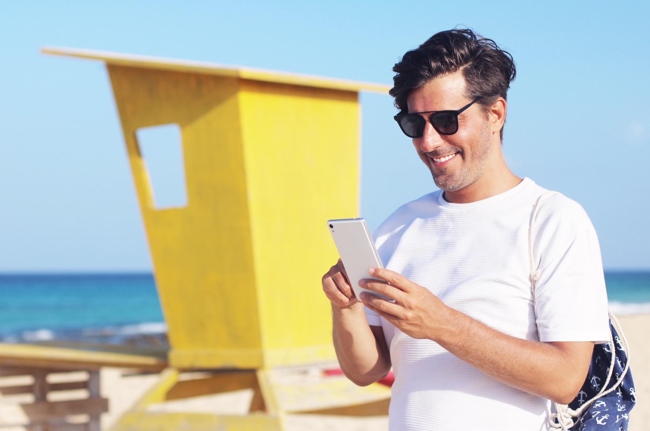 happy man using phone on vacation