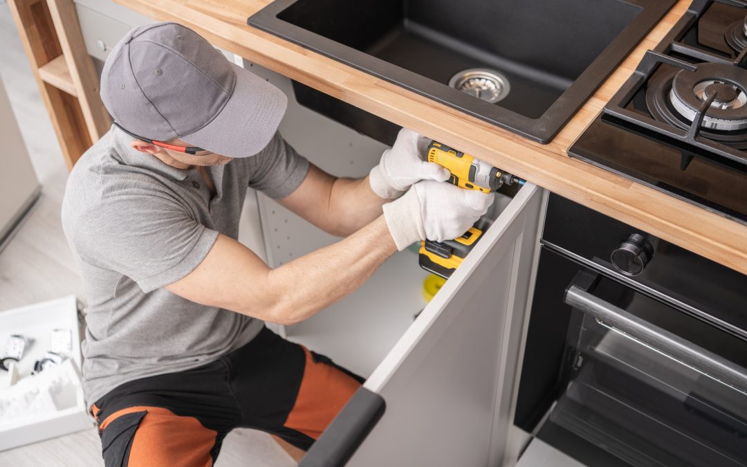 man replacing kitchen sink