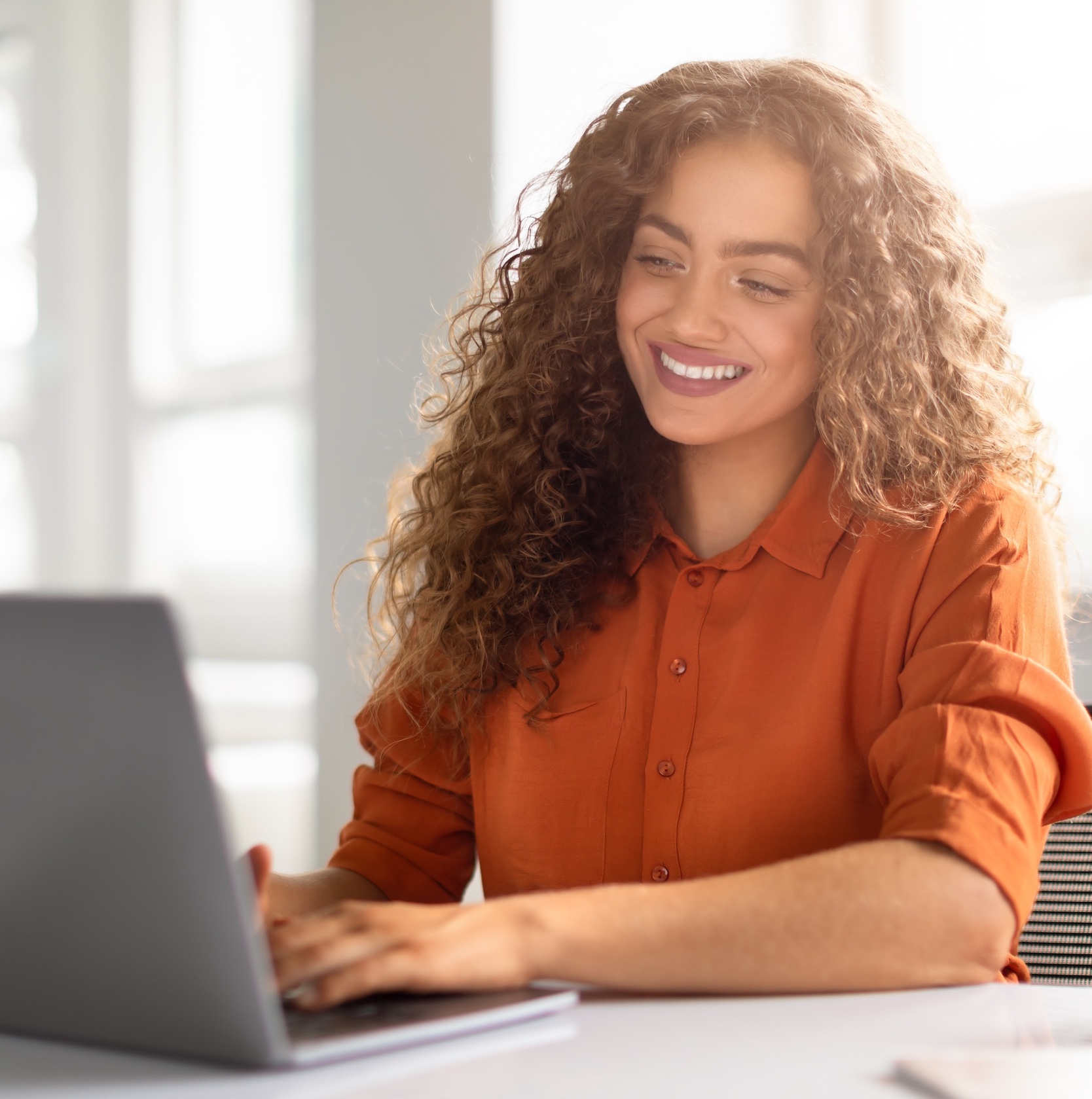 happy woman using her laptop