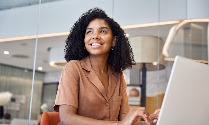 Smiling woman using a laptop - SBA Lending